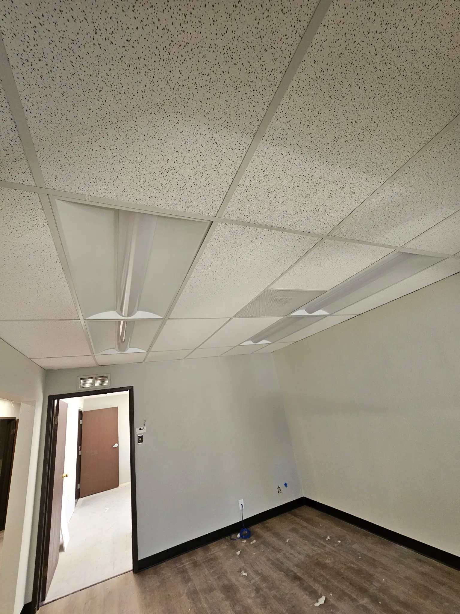 Finished suite with a new suspended acoustic tile ceiling and recessed lighting